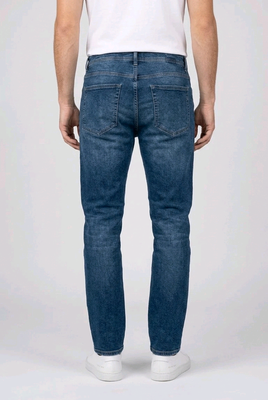 Man wearing blue jeans on a white back view