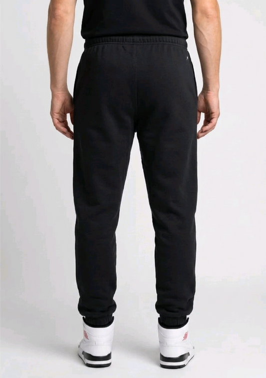 Man wearing black jordan joggers back view