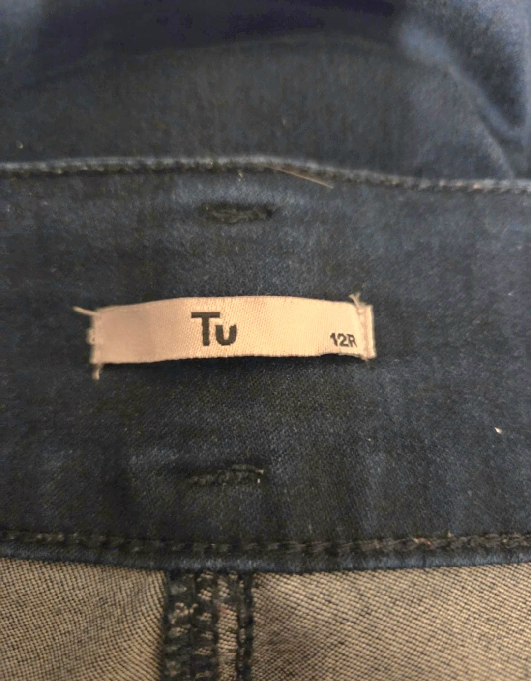 TU size label on blue fabric