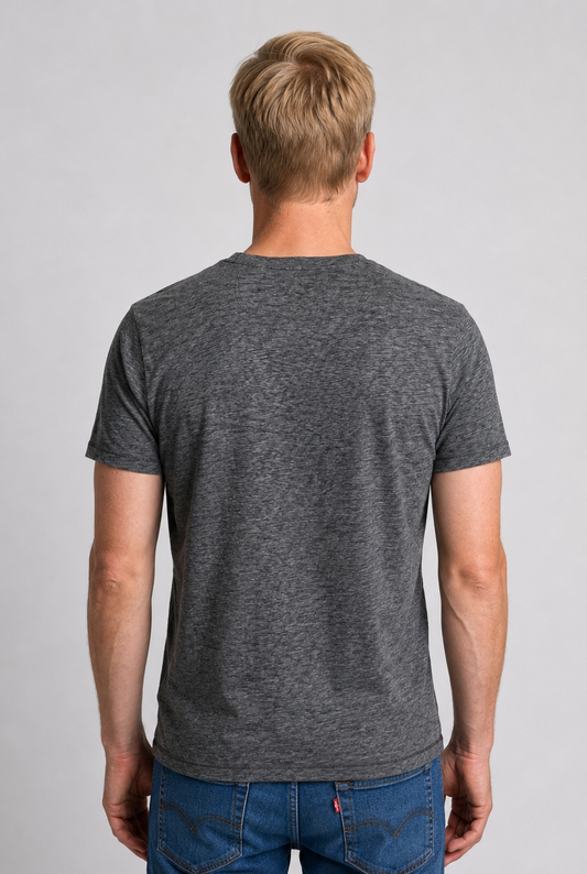 Man wearing a gray t-shirt and blue jeans