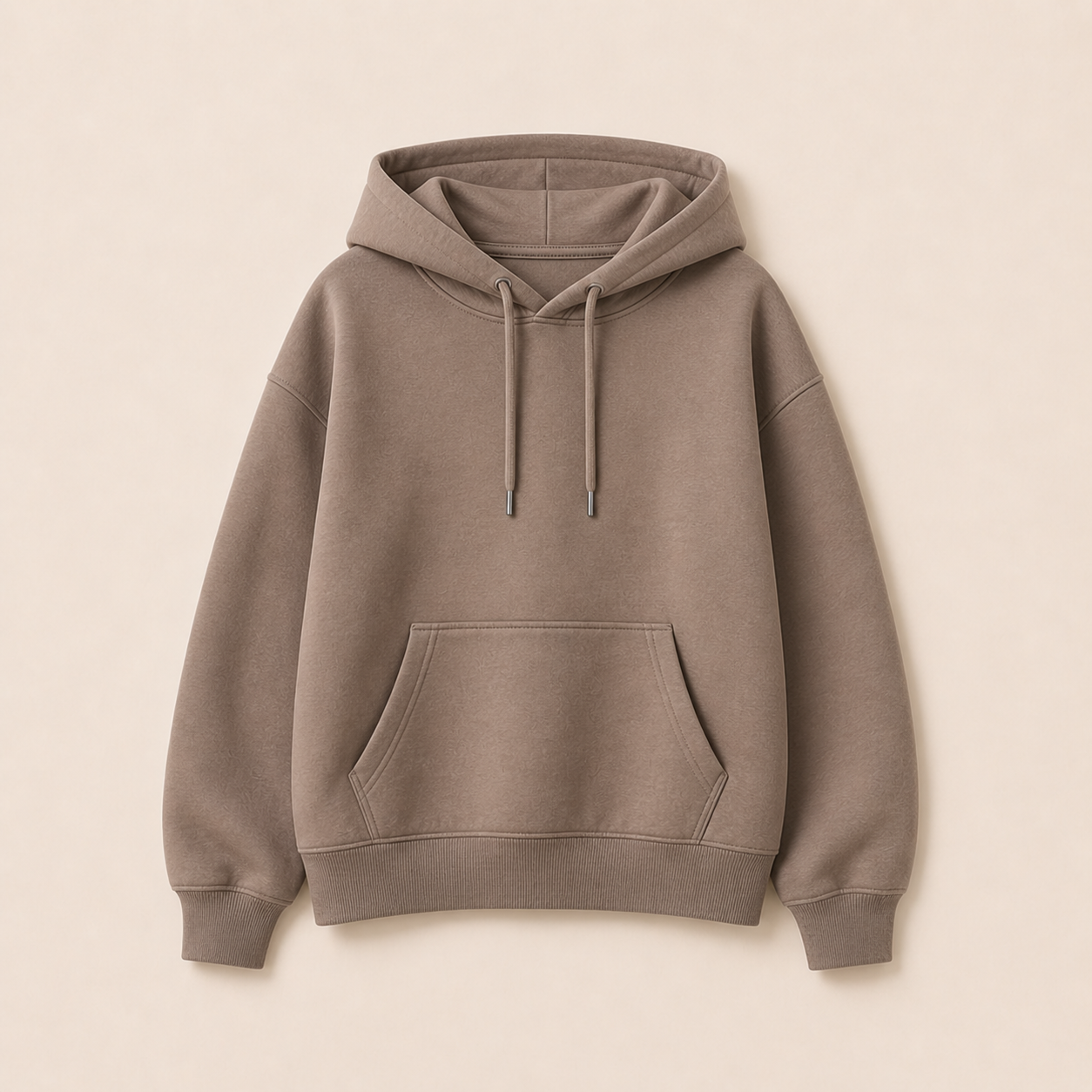 Soft beige hoodie on a plain background.