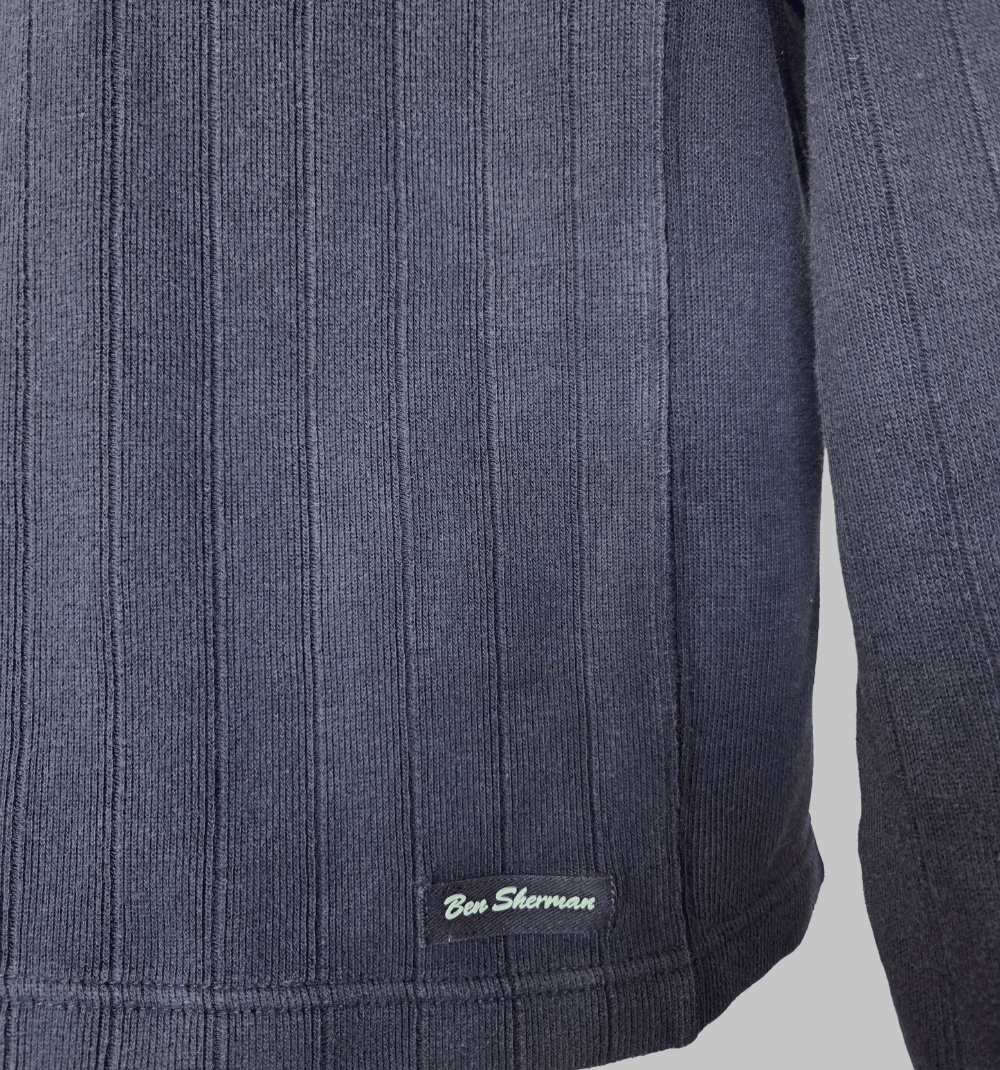 Ben Sherman Ribbed V-Neck Navy Blue Jumper close-up showing fabric texture and brand logo.