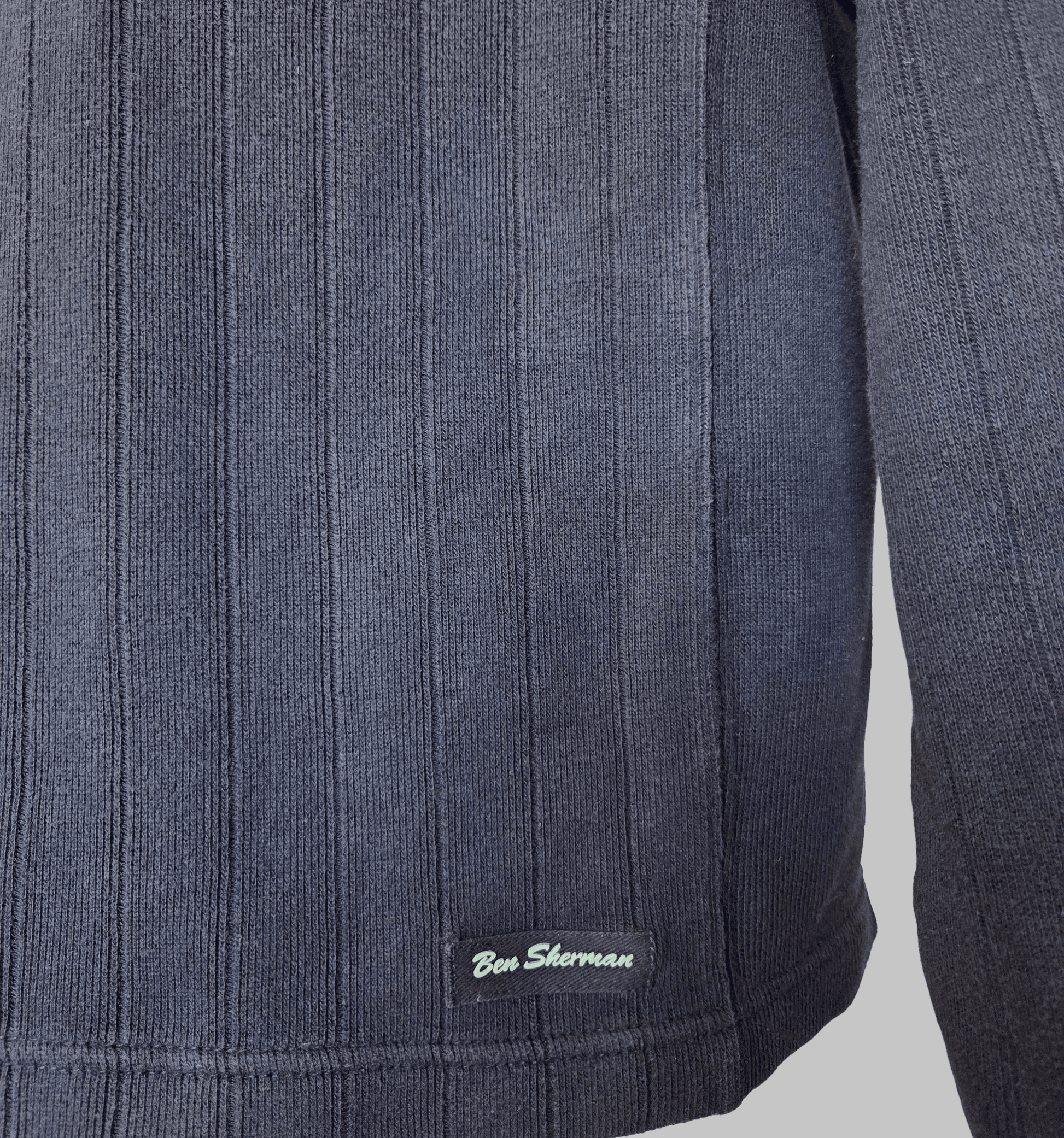 Ben Sherman Ribbed V-Neck Navy Blue Jumper close-up showing fabric texture and brand logo.
