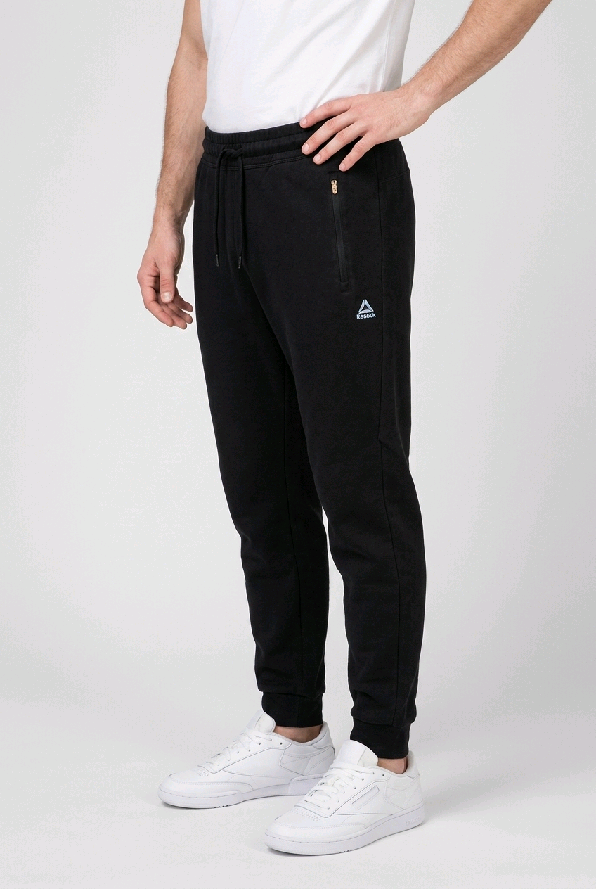 Man wearing a pair of black Reebok joggers