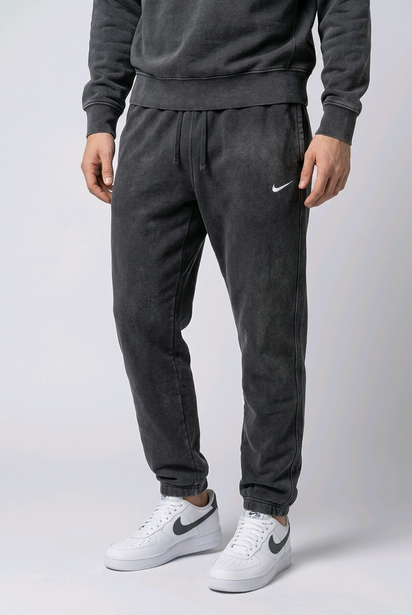 Man wearing black faded nike joggers