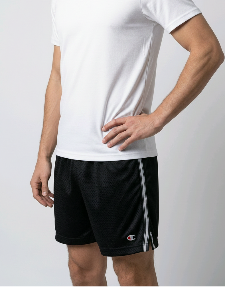 Man wearing black Champion shorts with a white t shirt
