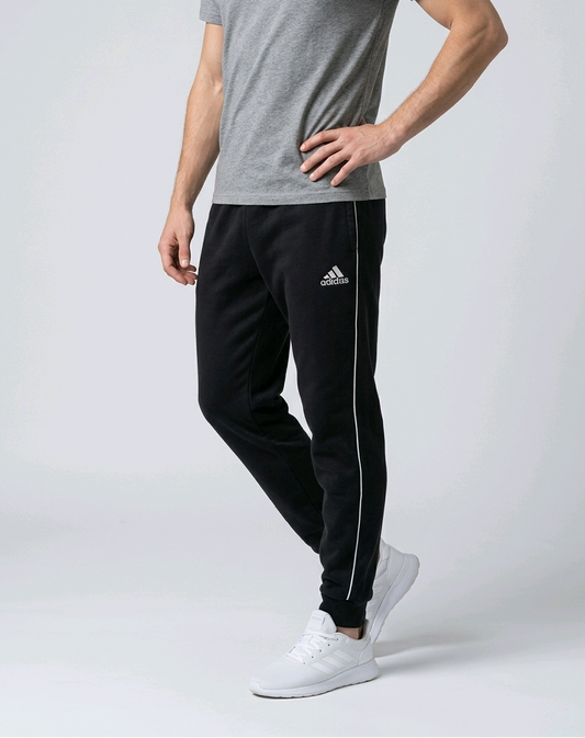Man wearing a pair of black Adidas joggers
