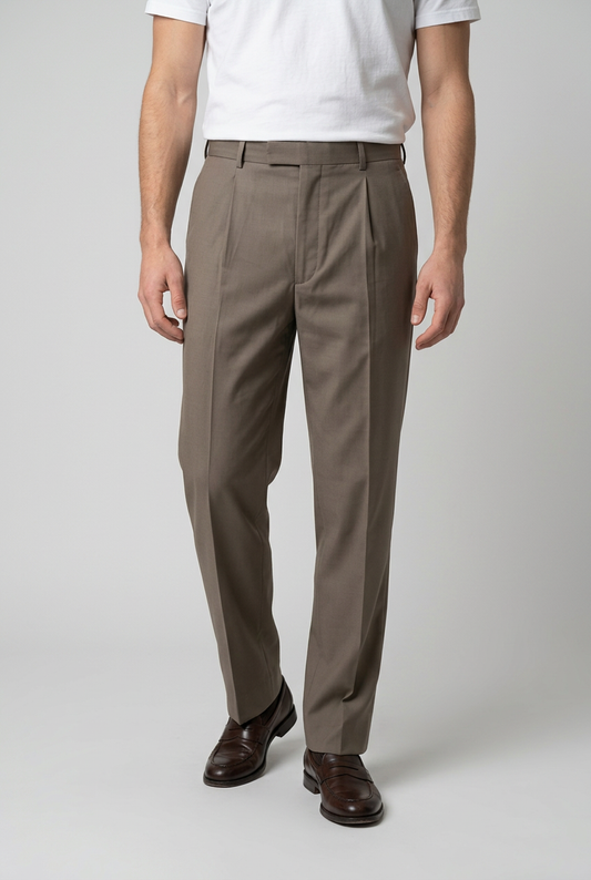 Man wearing brown trousers and a white shirt 