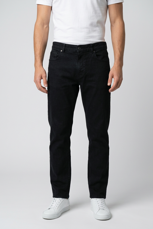 Man wearing a pair of black jeans with a white t shirt