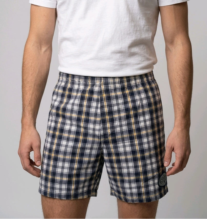 Man wearing plaid shorts and a white t shirt