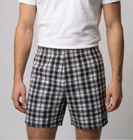 Man wearing plaid shorts and a white t shirt