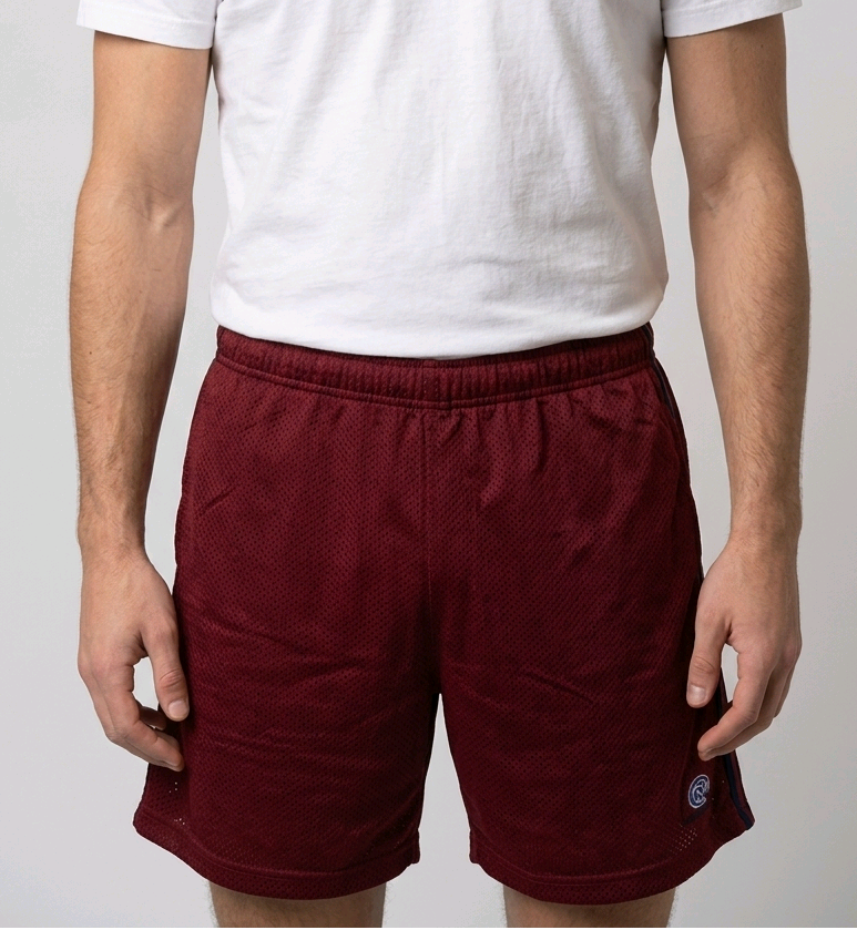 Man wearing red shorts and a white t shirt