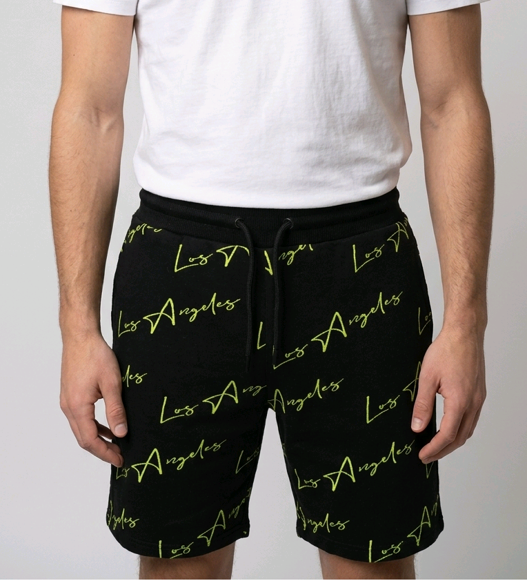 Man wearing black Los Angeles print shorts