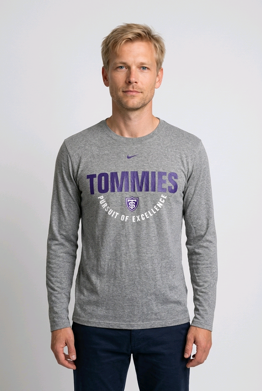 Man wearing a gray long-sleeve shirt with 'Tommies Pursuit of Excellence' text