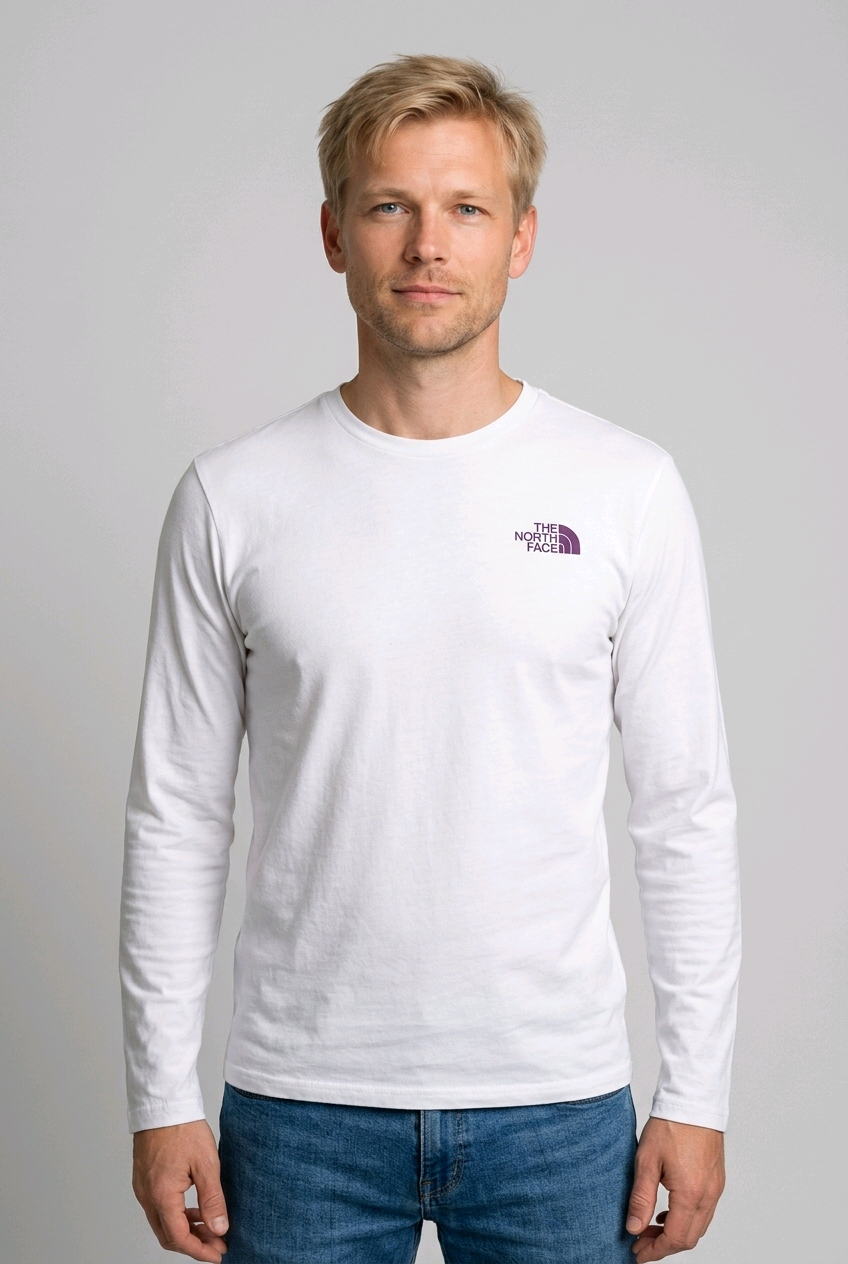 Man wearing a The North Fave white long-sleeve shirt with a logo