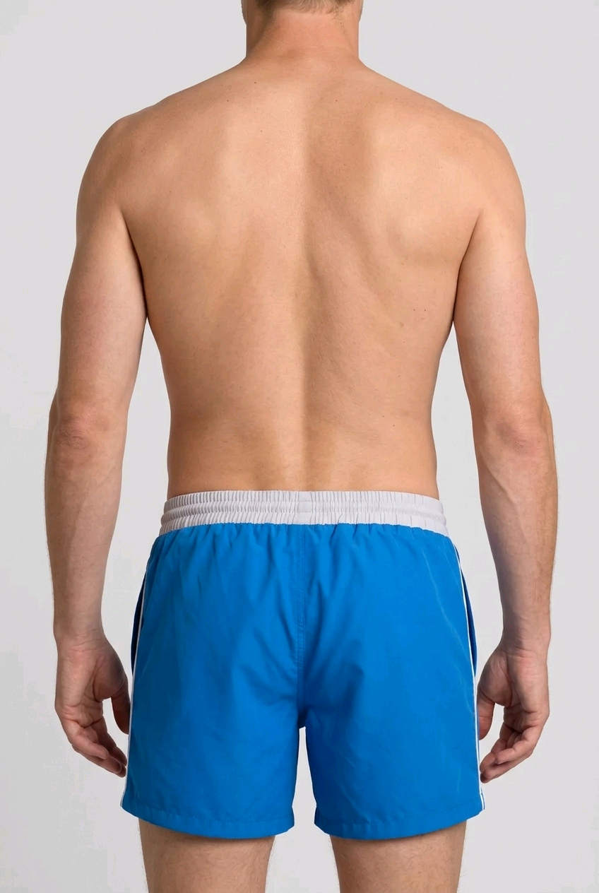 Man wearing blue swim shorts back view