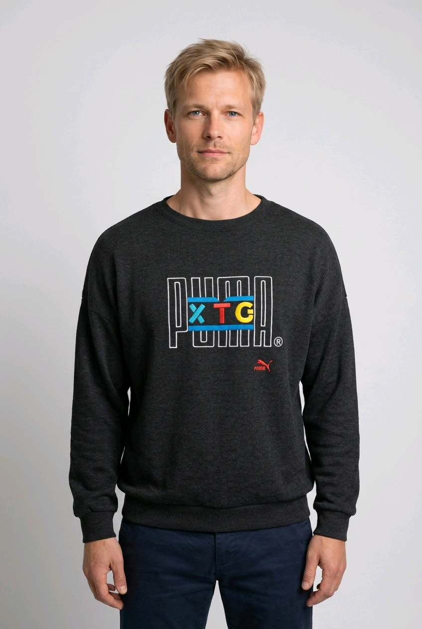 Man wearing a grey sweatshirt with colorful text and Puma logo 