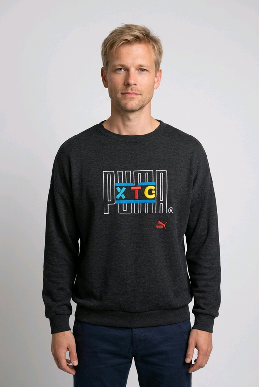 Man wearing a grey sweatshirt with colorful text and Puma logo 