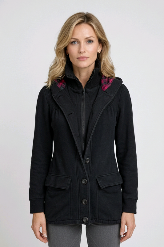 Woman wearing a black coat with pink accents