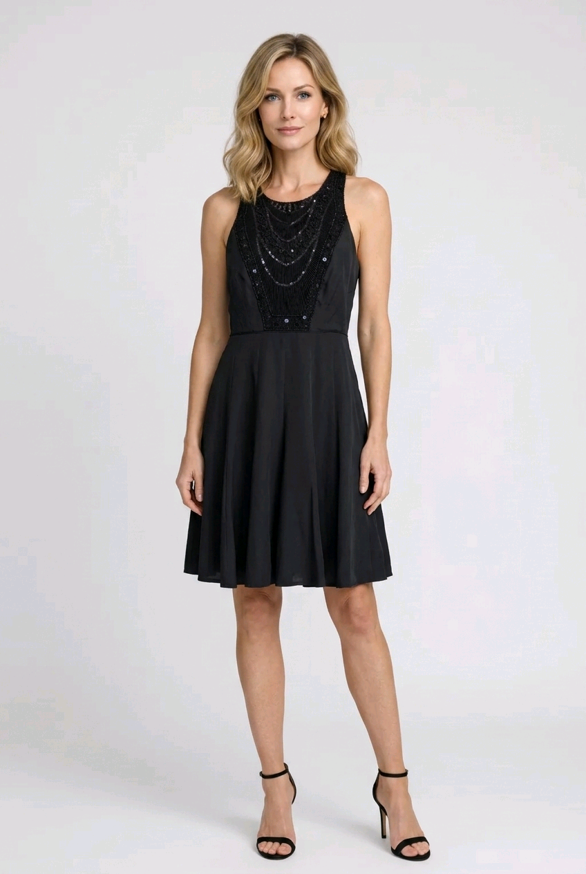 Woman wearing a black dress with bead embellishments 