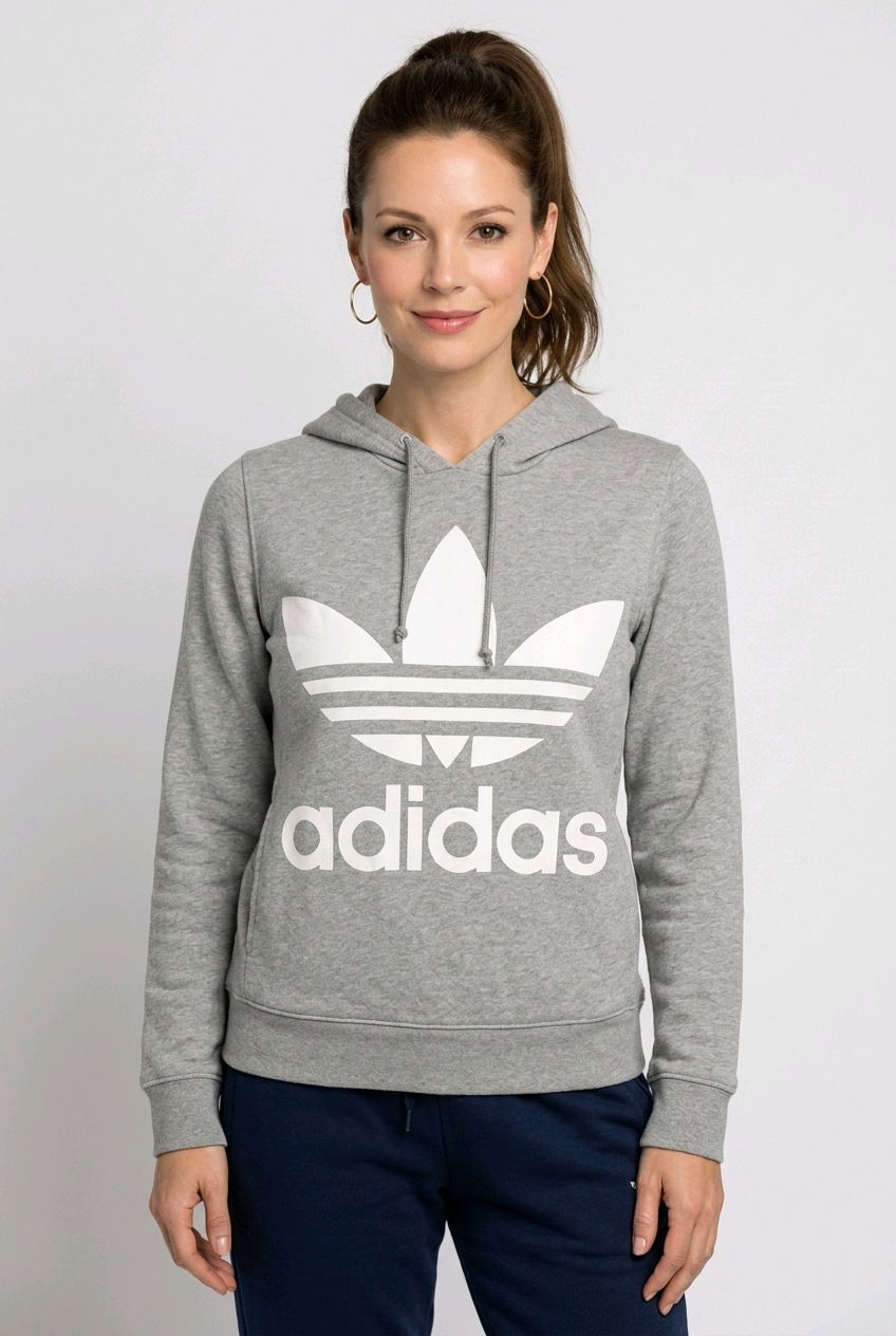 Woman wearing a grey Adidas hoodie with a white logo