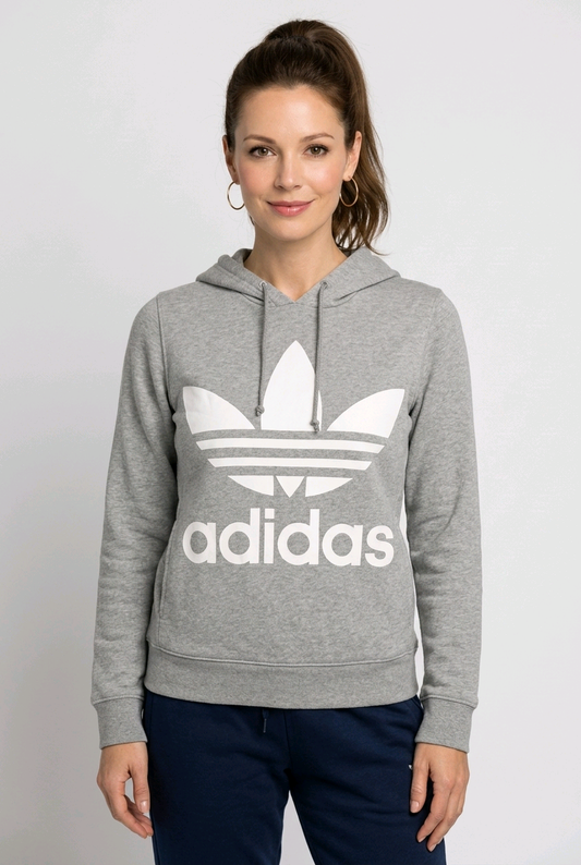 Woman wearing a grey Adidas hoodie with a white logo