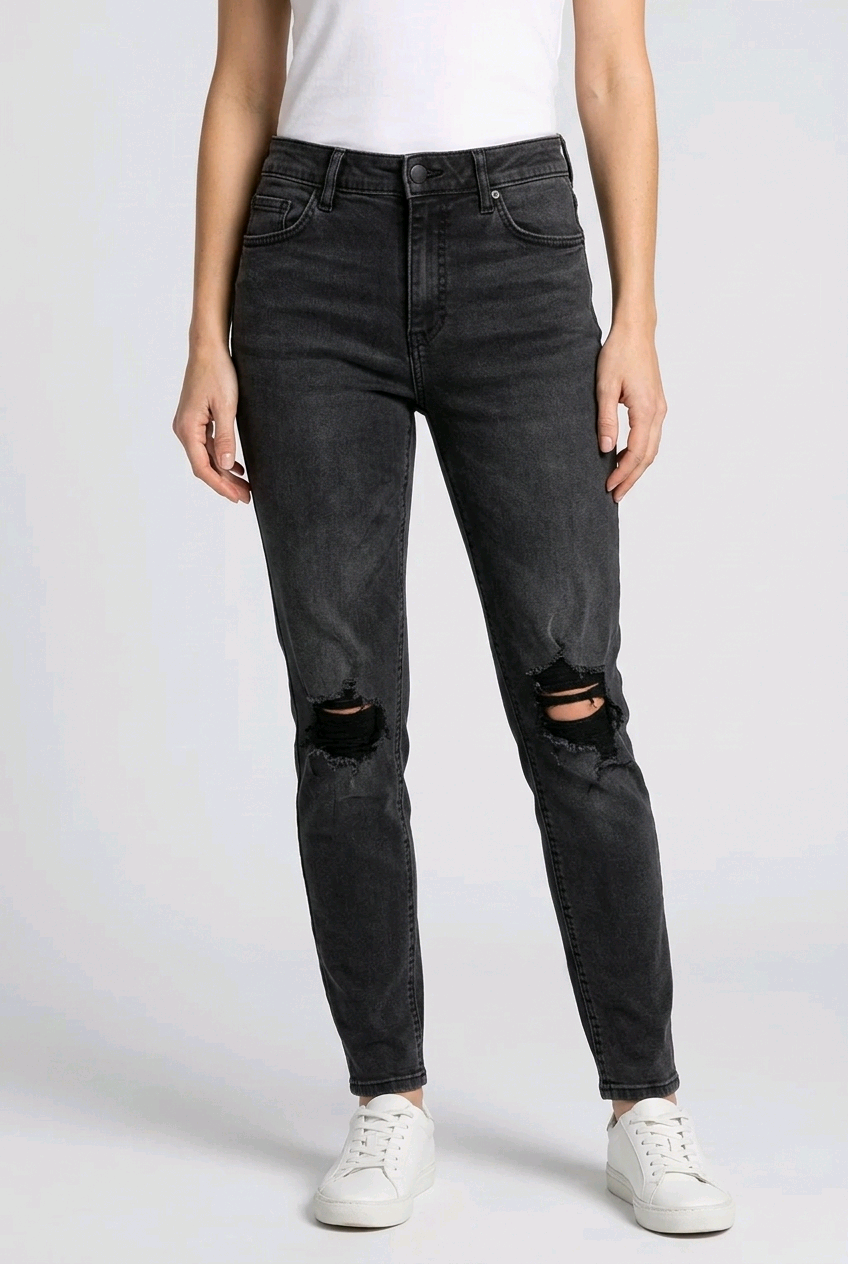 woman wearing black ripped jeans on a white background