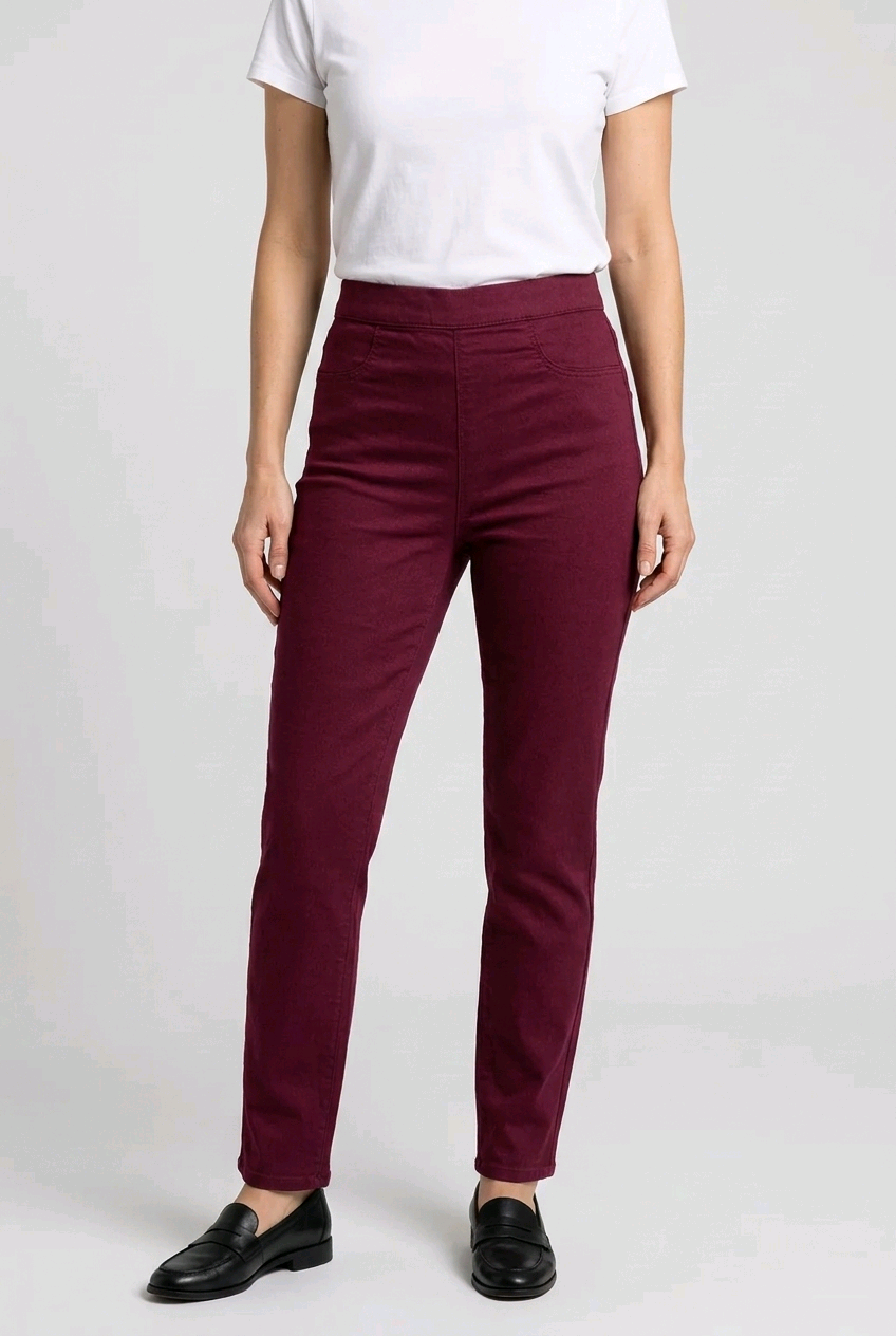 woman wearing maroon pants and a white shirt on a plain background