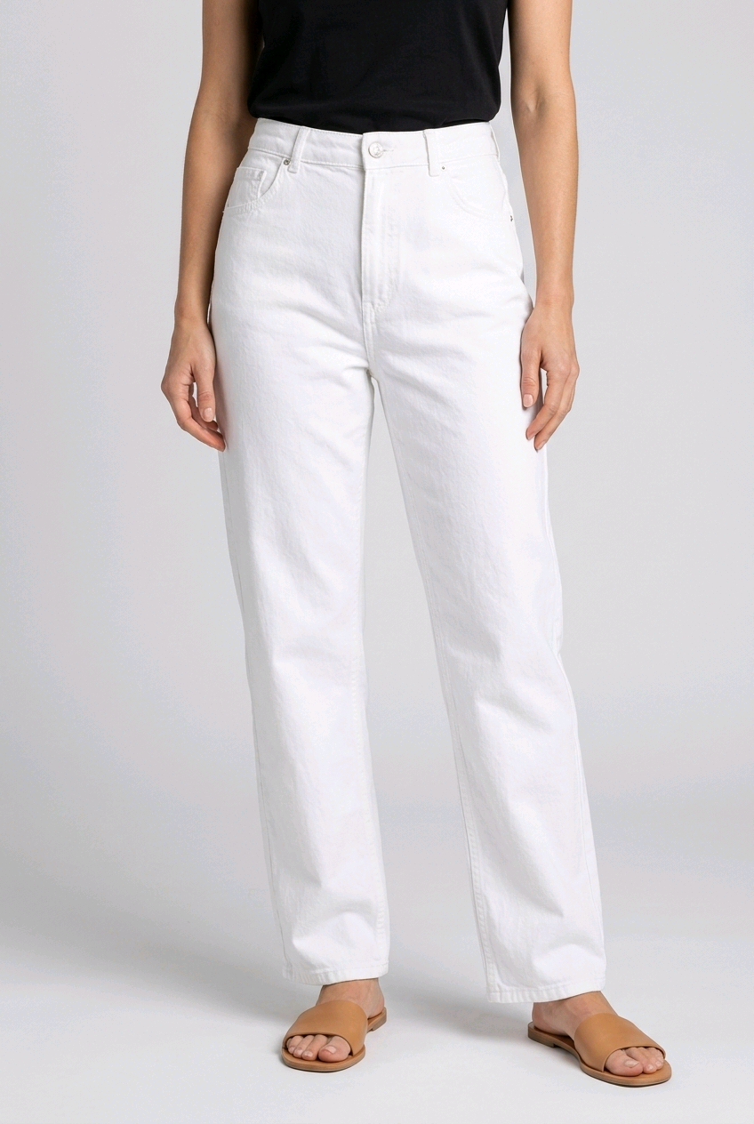 woman wearing white jeans on a plain background
