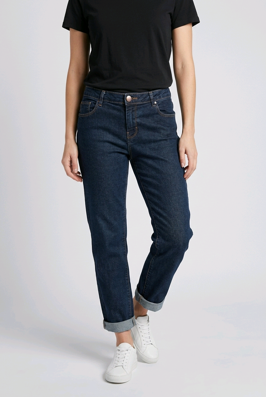 woman wearing dark blue jeans and a black shirt on a white background
