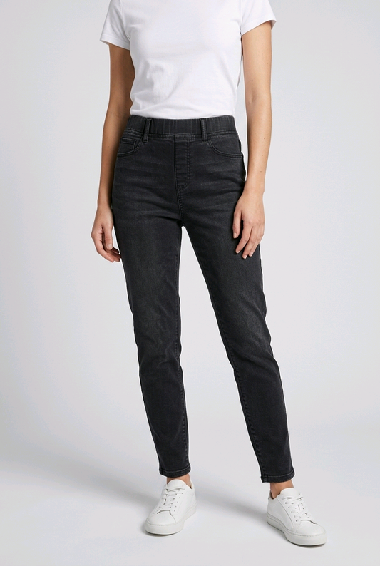 Woman wearing black jeggings and a white shirt 