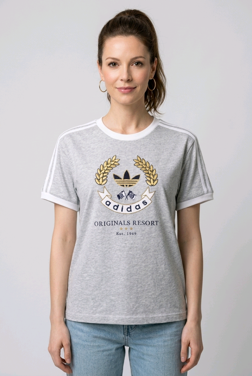 Woman wearing a gray Adidas t-shirt with a logo 