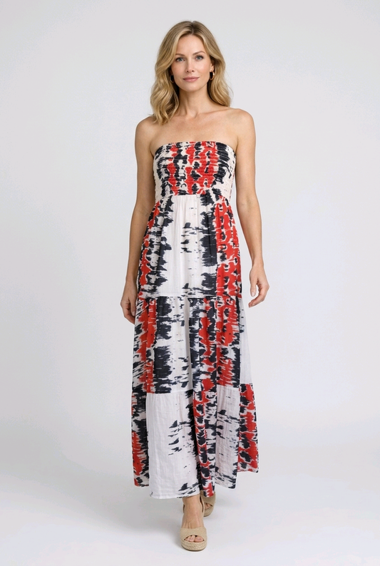 Woman wearing a strapless dress with red and navy abstract pattern 