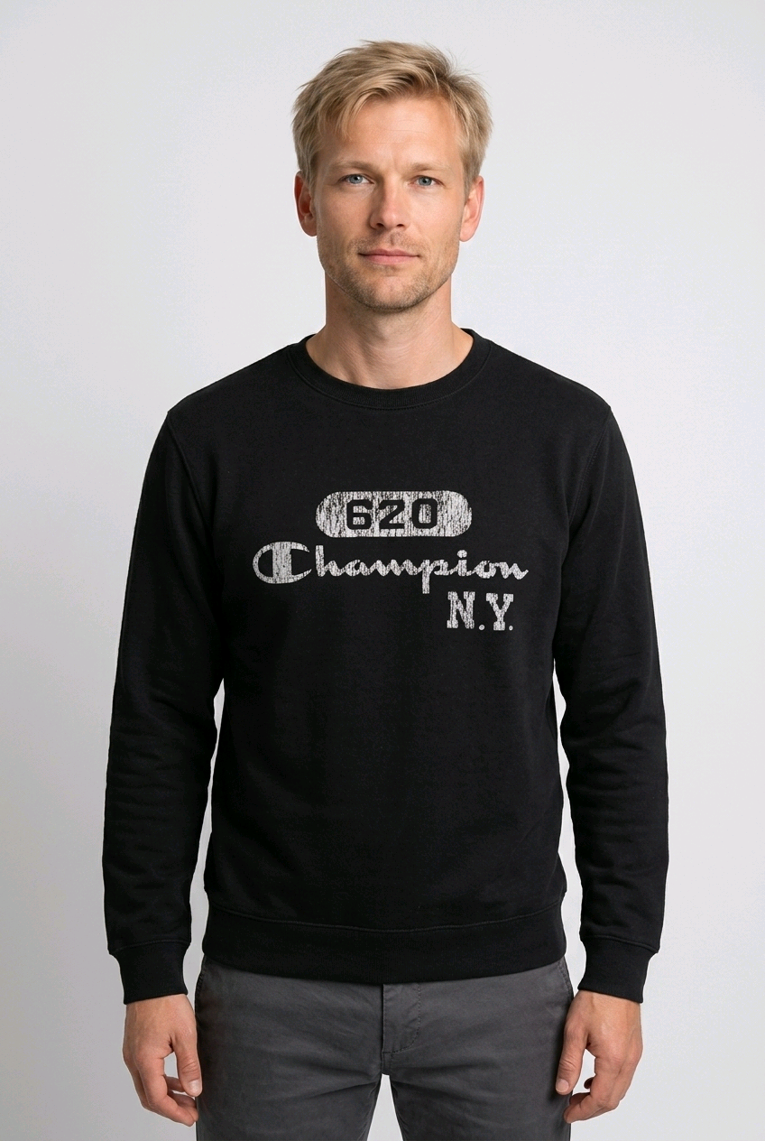 Man wearing a black Champion sweatshirt with white text 