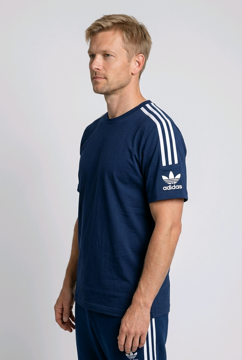 Side view of a man wearing an Adidas t shirt
