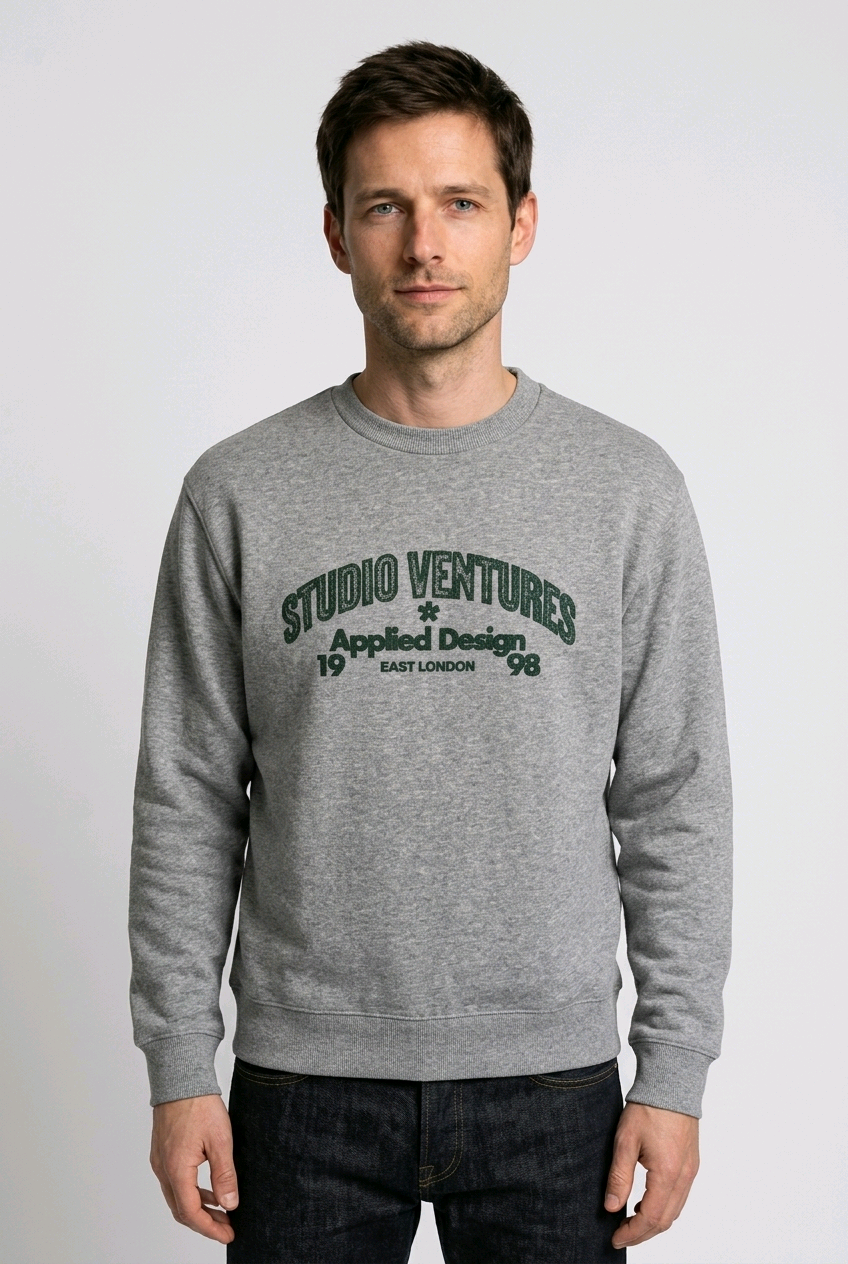Man wearing a gray sweatshirt with 'Studio Ventures' text 