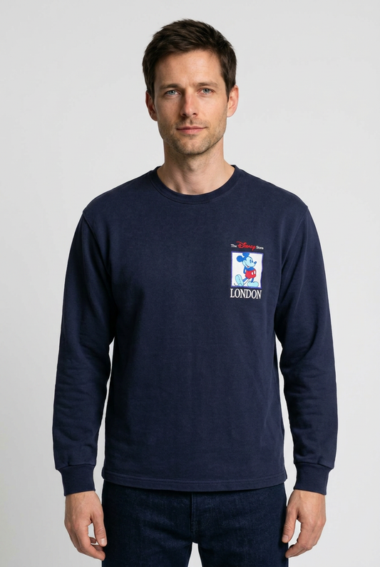 Man wearing a navy blue sweatshirt with a logo 
