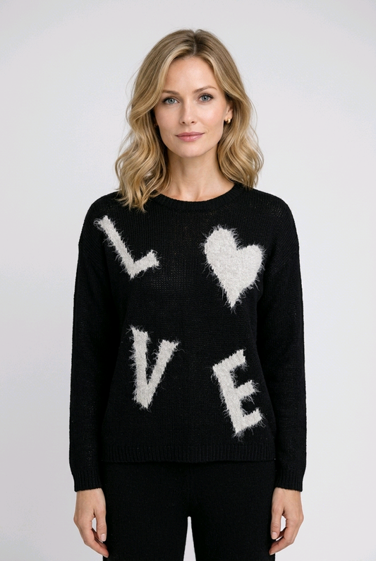 Woman wearing a black sweater with 'LOVE' and heart designs