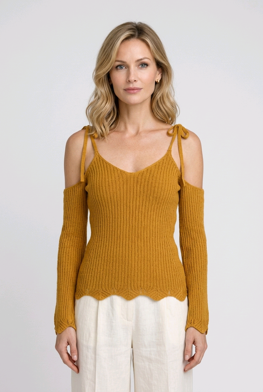 Woman wearing a mustard yellow knit top with cut-out shoulders 