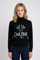 Woman wearing a black sweater with text and graphics 