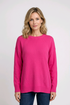 Woman wearing a bright pink sweater 