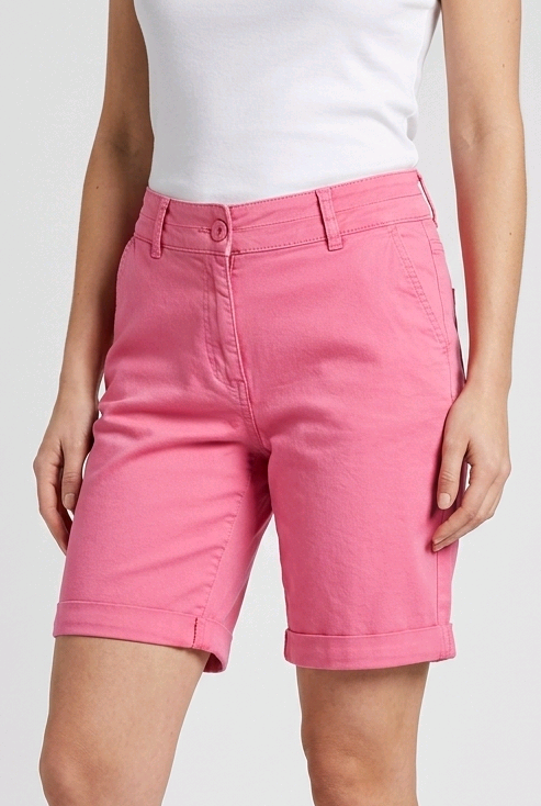 Woman wearing pink shorts and white t shirt