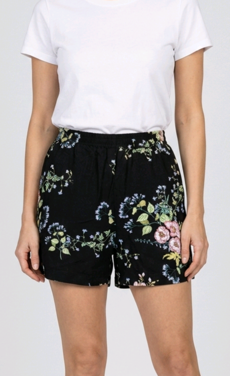 Woman wearing black floral shorts 