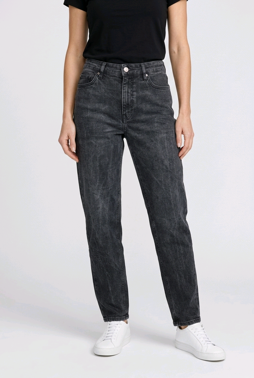 Person wearing black jeans and a black shirt on a white background
