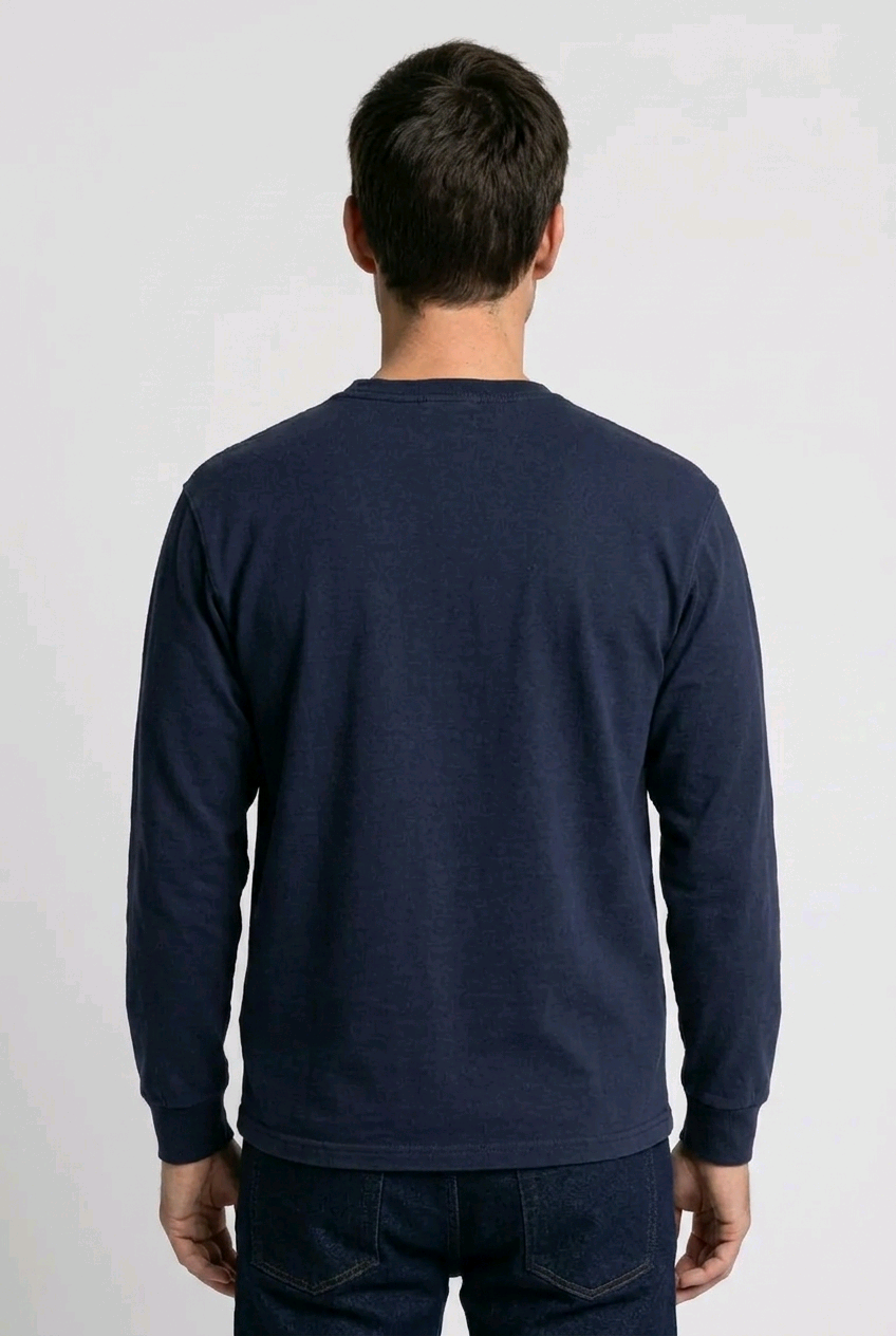 Man wearing a navy long-sleeve shirt on a white background