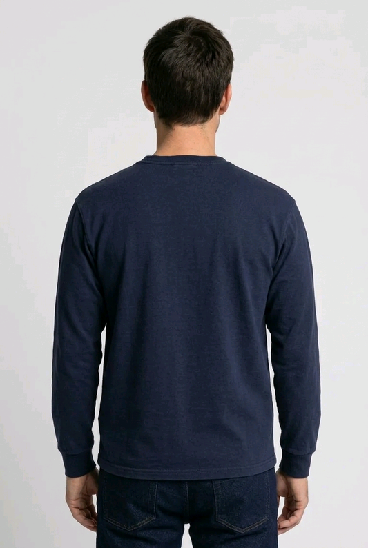 Man wearing a navy long-sleeve shirt on a white background