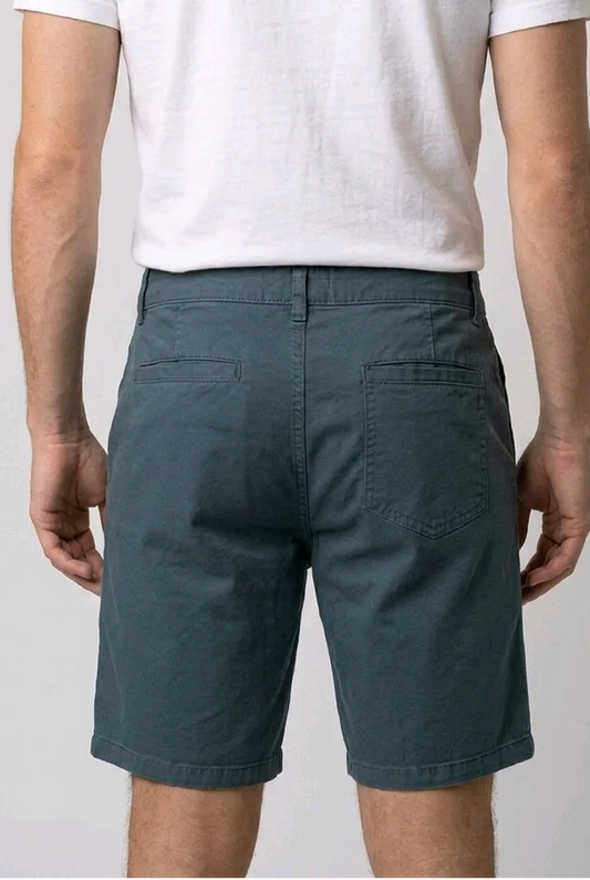 Person wearing a white t-shirt and teal shorts 