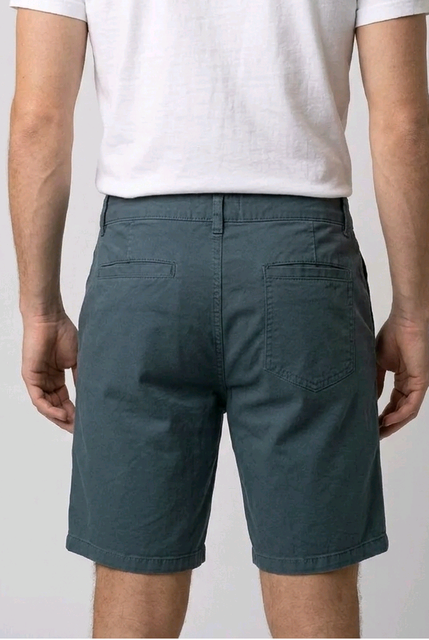 Person wearing a white t-shirt and teal shorts 