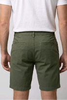  white t-shirt and green shorts back view