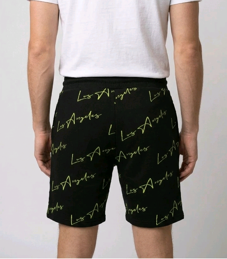 Man wearing black Los Angeles print shorts back view